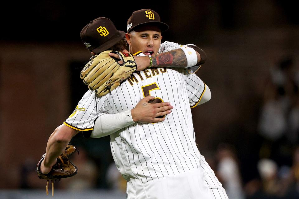 Manny Machado and Wil Myers embrace after the Padres' win in Game 3.