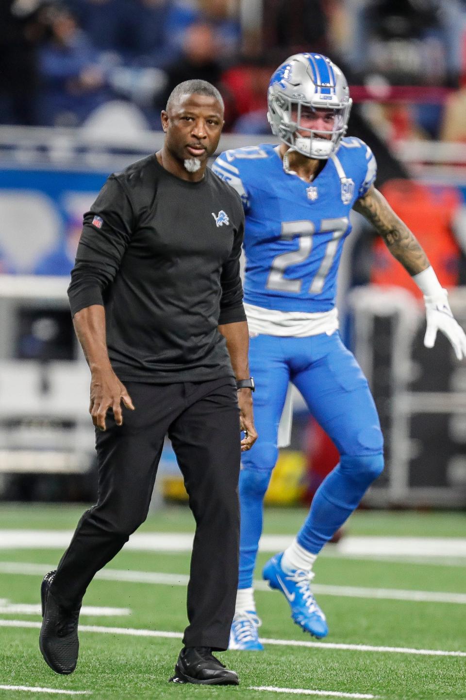 Detroit Lions defensive coordinator Aaron Glenn watches warmups before the NFC divisional playoff game vs. the Tampa Bay Buccaneers at Ford Field on Sunday, Jan. 21, 2024.