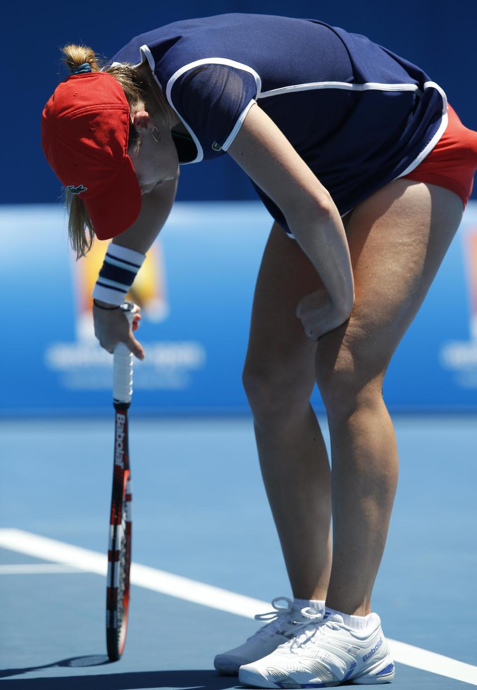 Alize Cornet of France rests on her racket during her second round match against Camila Giorgi of Italy at the Australian Open tennis championship in Melbourne, Australia, Thursday, Jan. 16, 2014.(AP Photo/Eugene Hoshiko)