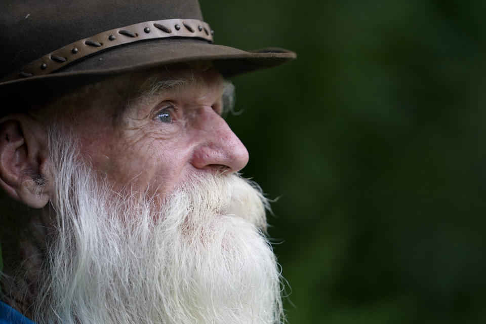 FILE — David Lidstone, 81, speaks with reporters during an interview on Tuesday, Aug. 10, 2021, in Boscawen, N.H. Lidstone, an off-the-grid New Hampshire hermit known to locals as "River Dave," had been living in a cabin in the woods along the Merrimack River, in Canterbury, N.H., for nearly three decades. A contempt of court hearing has been scheduled for Thursday, March 31, 2022, for Lidstone, accused of returning to live on property that he was ordered to stay away from. (AP Photo/Steven Senne, File)