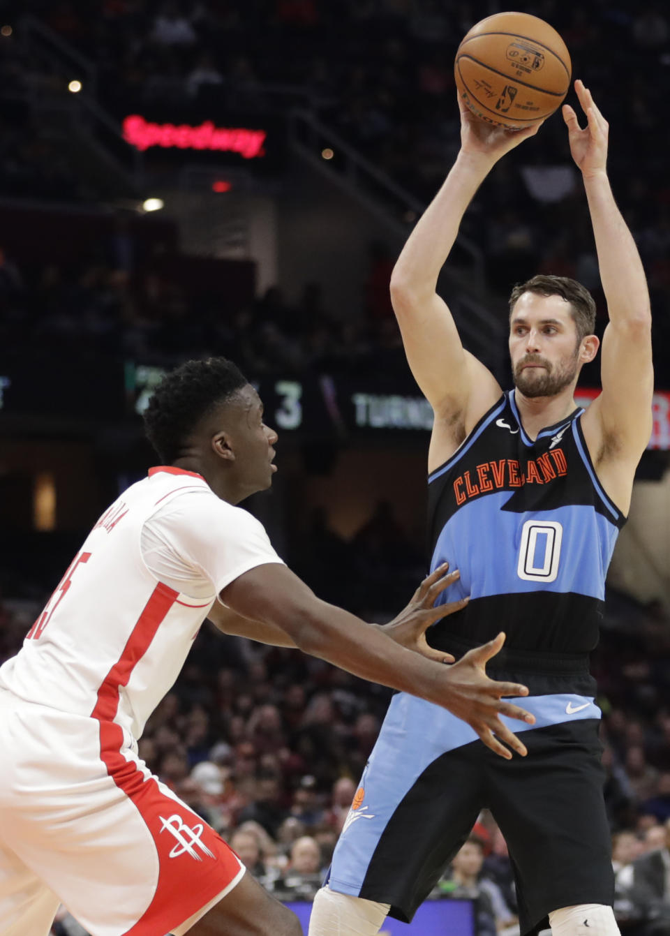 Cleveland Cavaliers' Kevin Love (0) looks to passes against Houston Rockets' Clint Capela (15) in the first half of an NBA basketball game, Wednesday, Dec. 11, 2019, in Cleveland. (AP Photo/Tony Dejak)