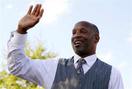 Reverend Michael Minor waves during a rally held by supporters of the Affordable Care Act (ACA), widely referred to as "Obamacare", outside the Jackson-Hinds Comprehensive Health Center in Jackson, Mississippi October 4, 2013. REUTERS/Jonathan Bachman