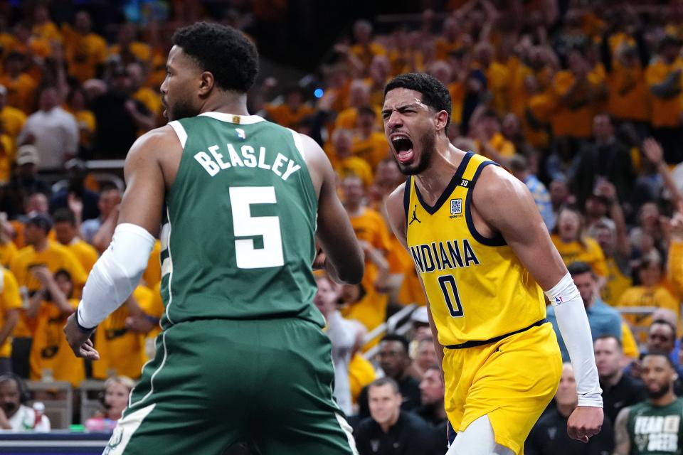 Pacers guard Tyrese Haliburton reacts after throwing down a dunk as Bucks guard Malik Beasley looks for the inbound pass during Game 6 on Thursday night.