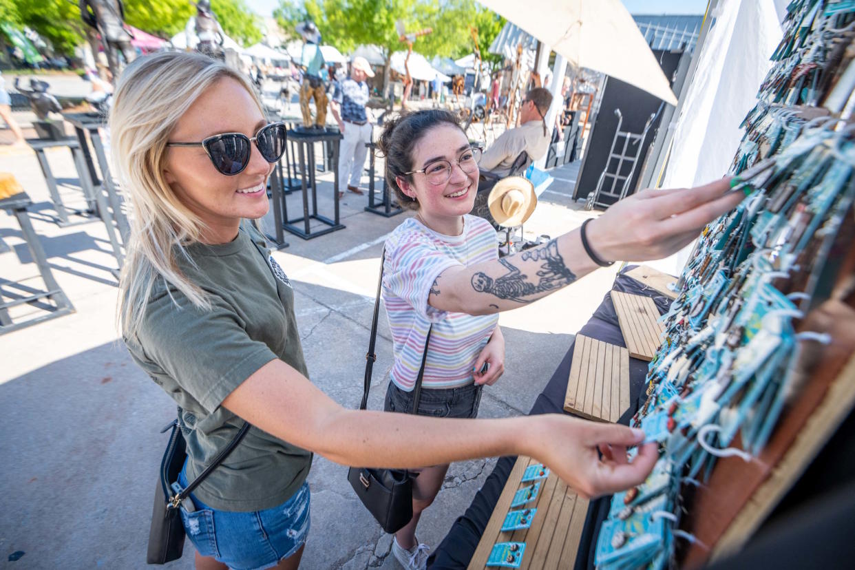 Festivalgoers shop for art at the Downtown Edmond Arts Festival.