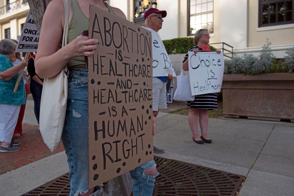 Demonstrators gather outside the Winston E. Arnow Federal Building in downtown Pensacola on Monday. The protest was called after a leaked U.S. Supreme Court opinion indicated the court will rule in favor of overturning Roe v. Wade and clear the path for states to make abortion illegal.