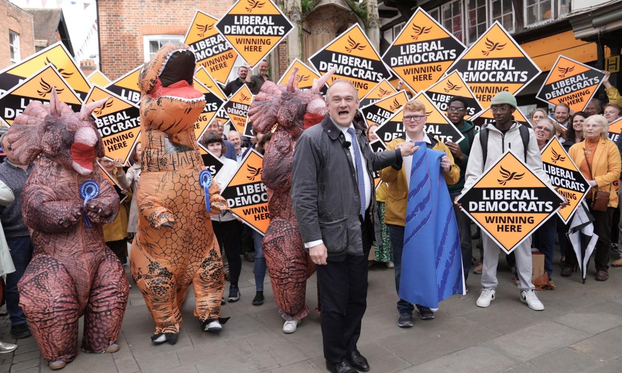 <span>The Liberal Democrat leader Ed Davey stands in front of Tory 'dinosaurs' at a rally in Winchester on Friday.</span><span>Photograph: Stefan Rousseau/PA</span>