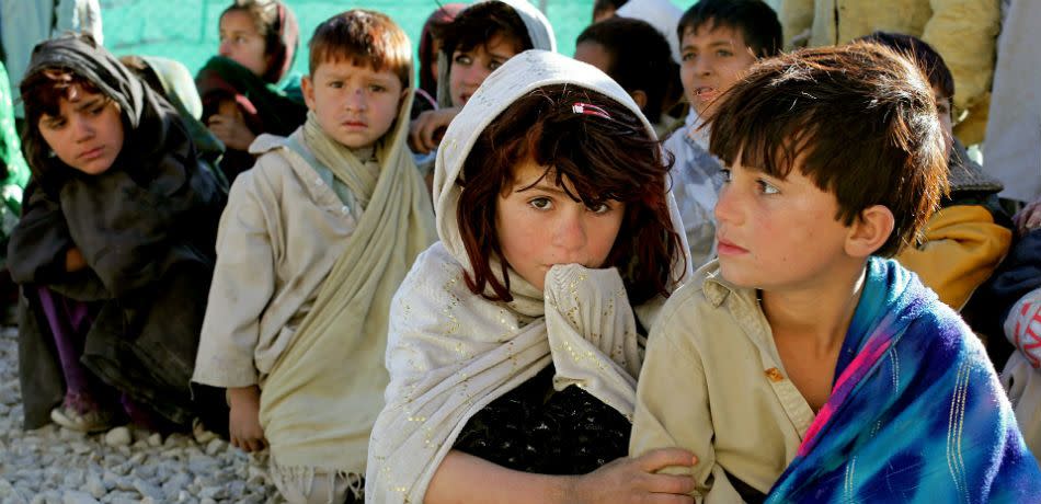 A candid photo of children in Afghanistan sitting on the ground