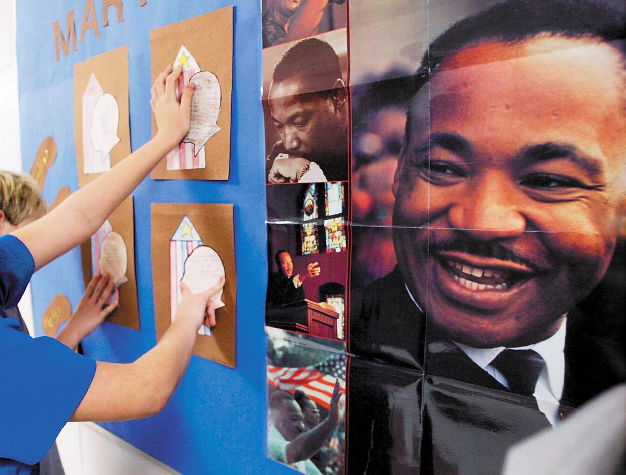 Fifth-graders decorate a bulletin board outside their classroom. (Marshfield News-Herald/Casey Riffe/AP) 