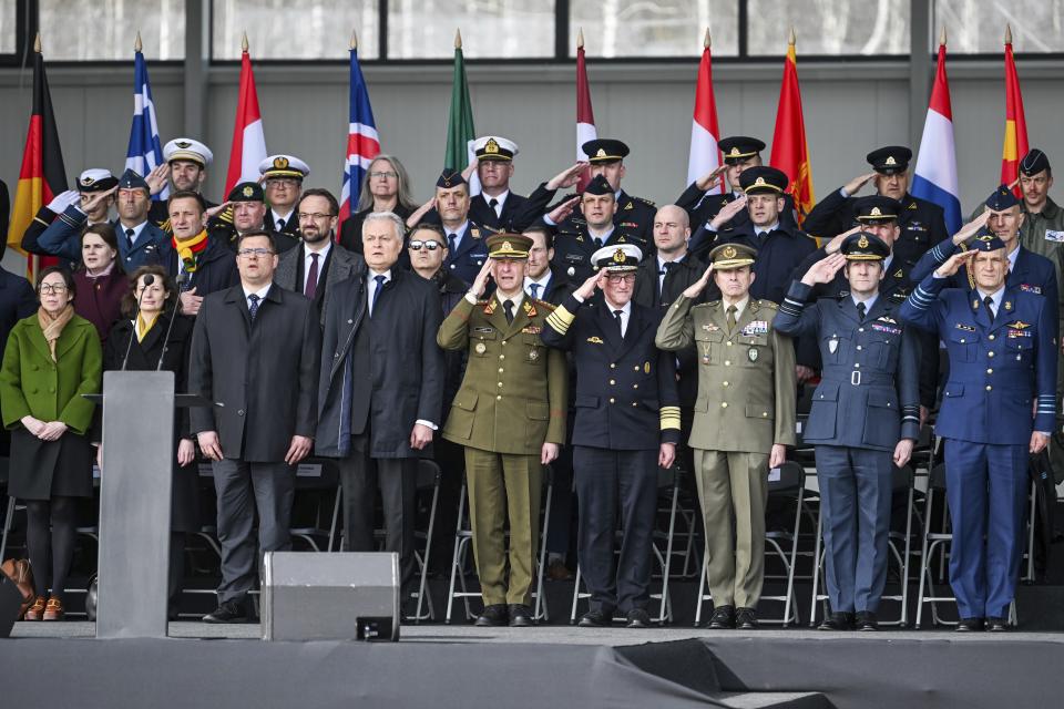In this photo provided by Lithuanian Ministry of National Defense, Lithuania's President Gitanas Nauseda, second from left, and other high NATO officials, representatives of foreign diplomatic missions during a celebration for Lithuania's NATO membership 20th anniversary at the Siauliai airbase, some 230 km (144 miles) east of the capital Vilnius, Lithuania, Thursday, March 28, 2024. (Alfredas Pliadis/Lithuanian Ministry of National Defense via AP)