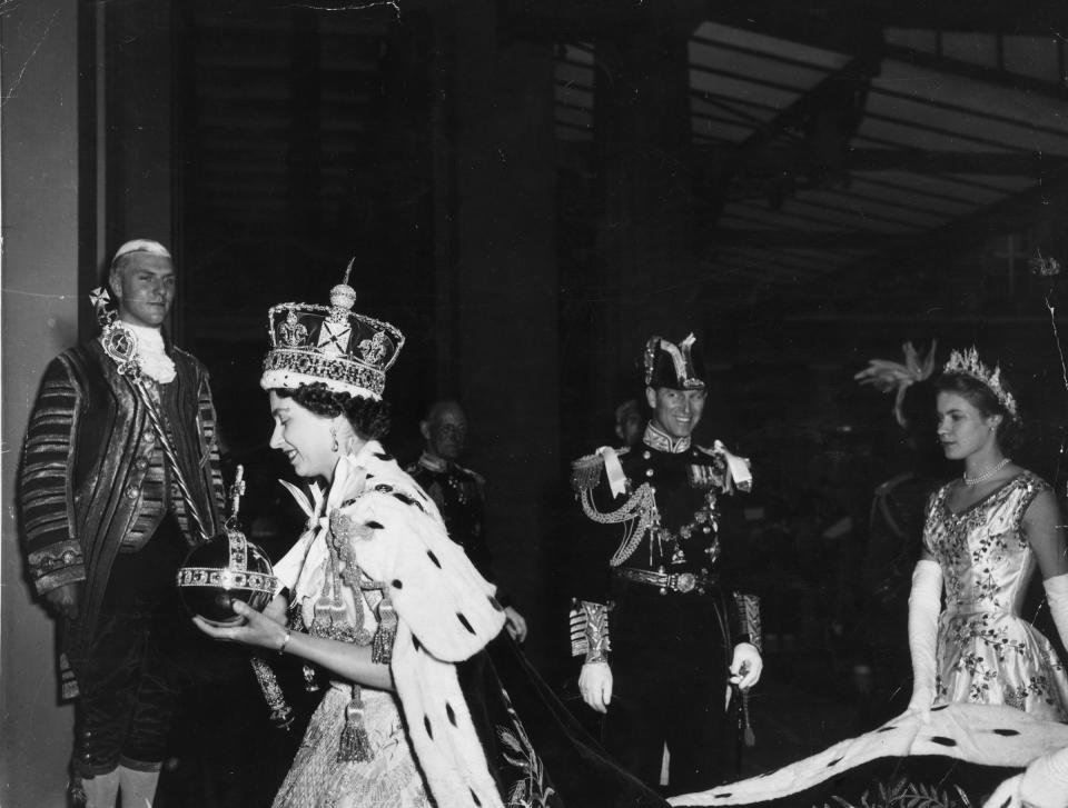 Queen Elizabeth II, wearing the Imperial State crown and carrying the Orb and Sceptre, returns to Buckingham Palace from Westminster Abbey, London, following her Coronation.<span class="copyright">Topical Press Agency/Getty Images</span>