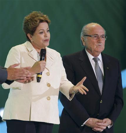 Brazil's President Dilma Rousseff speaks next to FIFA President Sepp Blatter during the draw for the 2014 World Cup at the Costa do Sauipe resort in Sao Joao da Mata, Bahia state, December 6, 2013. REUTERS/Paulo Whitaker