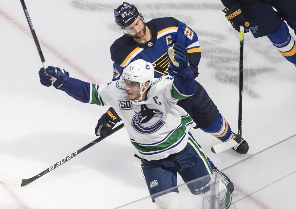 Vancouver Canucks' Bo Horvat (53) celebrates his goal as he is followed by St. Louis Blues' Alex Pietrangelo (27) during overtime in an NHL hockey Stanley Cup first-round playoff series, Friday, Aug. 14, 2020, in Edmonton, Alberta. (Jason Franson/The Canadian Press via AP)