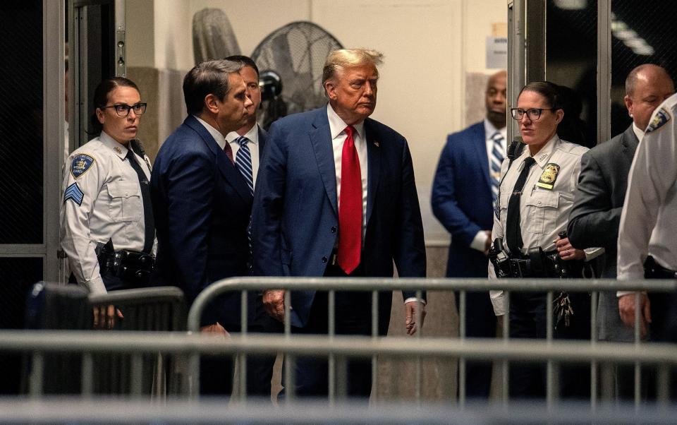 Donald Trump returns from a break as jury selection begins in his trial at Manhattan Criminal Court