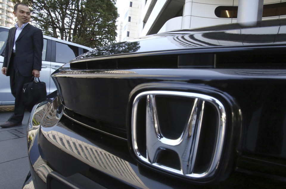 A visitor looks at a car displayed at the showroom at the Honda Motor Co. headquarters in Tokyo, Wednesday, May 8, 2019. Honda reported a loss for January-March, despite growing sales, as an unfavorable exchange rate, income tax expenses and other costs hurt results. (AP Photo/Koji Sasahara)