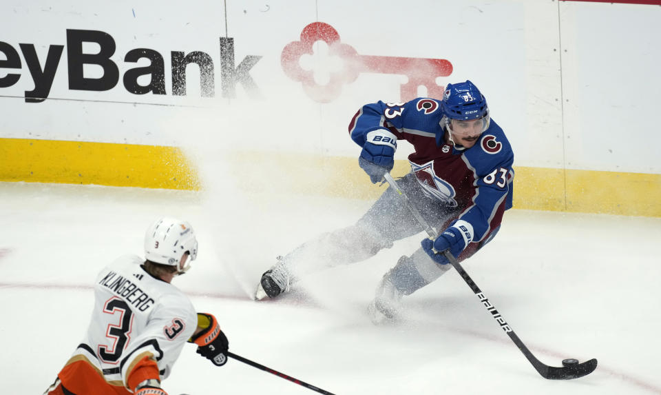 Colorado Avalanche left wing Matt Nieto, right, makes a hard stop while collecting the puck as Anaheim Ducks defenseman John Klingberg watches during the first period of an NHL hockey game Thursday, Jan. 26, 2023, in Denver. (AP Photo/David Zalubowski)