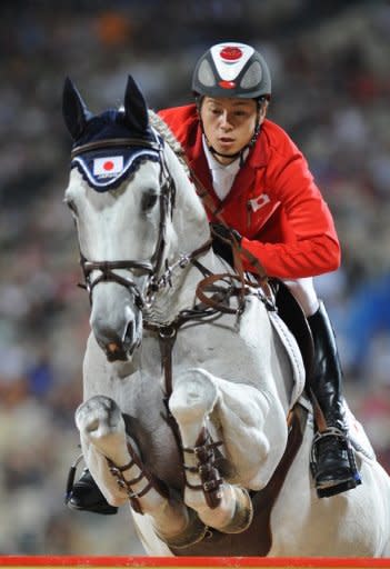 Eiken Sato, the younger brother of Kenki, rides Cayak during the Equestrian Jumping Individual competition at the 2008 Beijing Olympics in Hong Kong