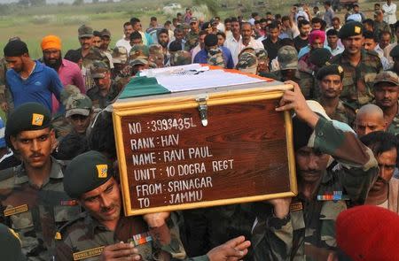 Indian army soldiers carry a coffin containing the body of their fallen colleague Ravi Paul, who was killed in Sunday's attack at an Indian army base in Kashmir's Uri, during his funeral in Sarwa village in Samba district, south of Jammu, September 19, 2016. REUTERS/Mukesh Gupta