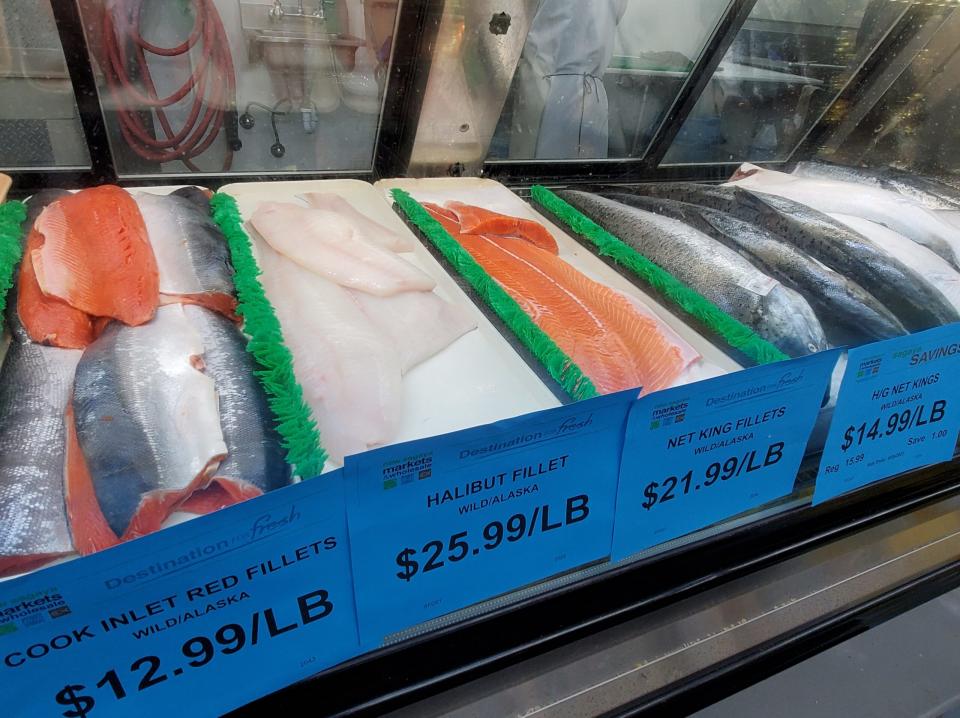 Wild seafood -- salmon and halibut from different parts of Alaska -- is labeled and displayed on June 28 at Sagaya City Market in downtown Anchorage. The industry has been emphasizing the wild nature of Alaska salmon and other fish to differentiate it from other seafood in global markets. (Photo by Yereth Rosen/Alaska Beacon)