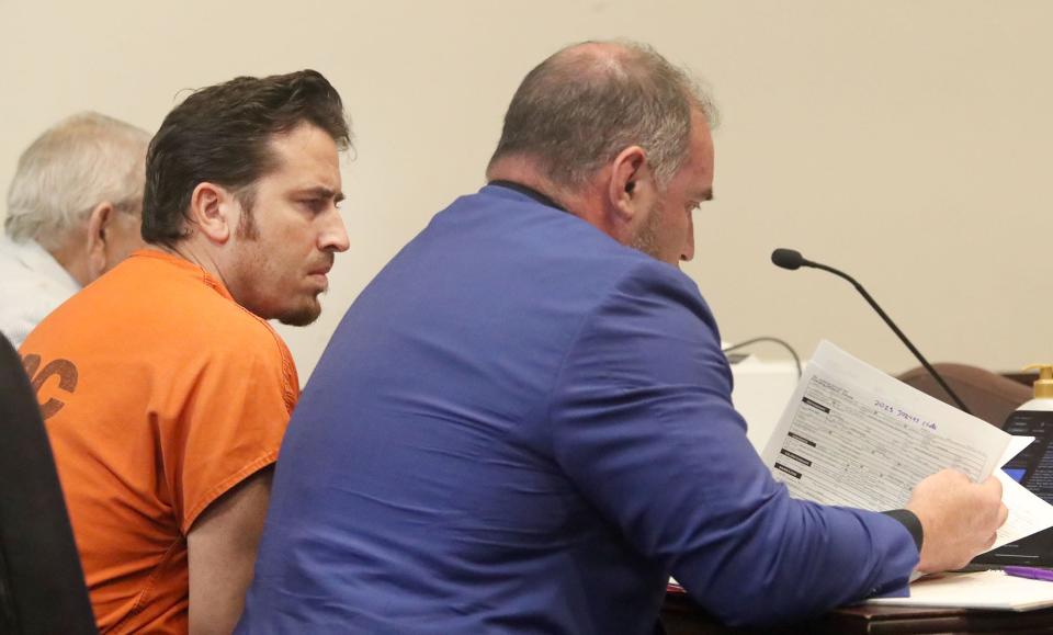 Arin Hankerd, the former Atlantic High School teacher and coach charged with sexual offenses involving students, sits with his defense attorneys, Wednesday, May 24, 2023, during a hearing at the S. James Foxman Justice Center in Daytona Beach.