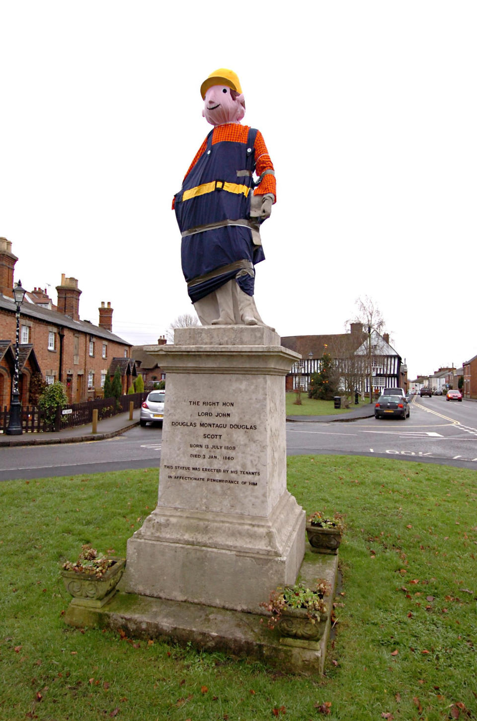 A village is hunting festive pranksters who have turned a statue of its most famous son into PEPPA PIG. The statue of Lord John Scott, who died in 1860, is a Christmas target for jokers in Dunchurch, near Rugby, Warks. Hilarious pictures show the monument draped in a pink sheet with arms stretched out and a huge pink papier mache head resembling kids' TV favourite. The statue has previously been turned into Harry Potter, Shrek, Happy Feet, Pikachu, Homer Simpson, an Olympic athlete and The Grinch in an annual tradition dating back to the 1970s.