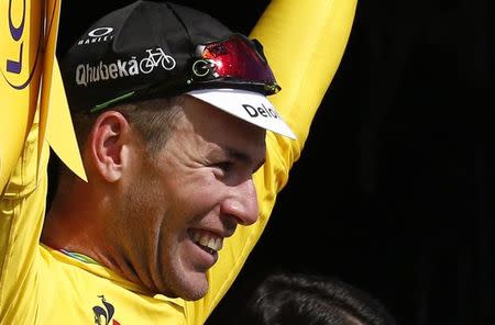 Cycling - Tour de France cycling race - The 188-km (117 miles) 1st stage from Mont Saint-Michel to Utah Beach Sainte-Marie-du-Mont, France - 02/07/2016 - Team Dimension Data rider Mark Cavendish of Britain reacts on podium. REUTERS/Juan Medina