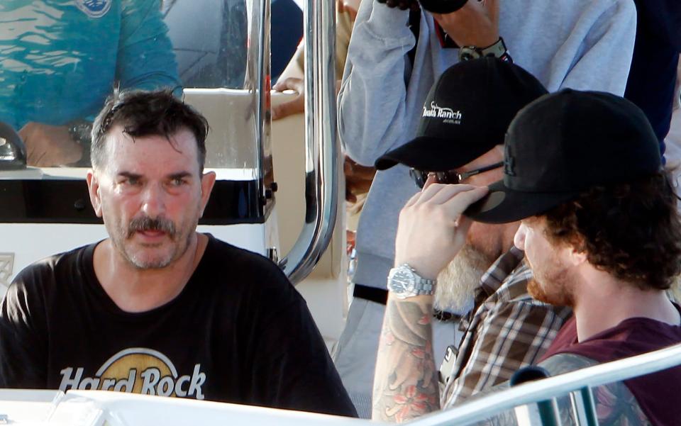 Amelia's father on a speedboat with family members during the search for the student, who was a on a gap year in Cambodia - AP