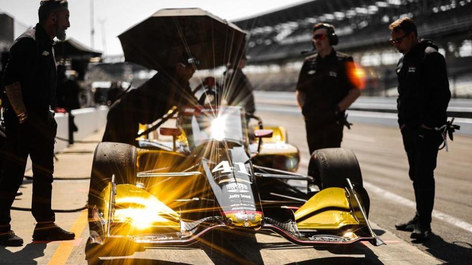 a group of people around a race car