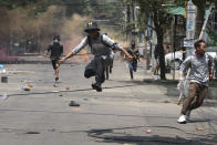 FILE - In this March 31, 2021, file photo, anti-coup protesters run away from military forces during a demonstration in Yangon. The military takeover of Myanmar early in the morning of Feb. 1 reversed the country's slow climb toward democracy after five decades of army rule. But Myanmar's citizens were not shy about demanding their democracy be restored. (AP Photo, File)