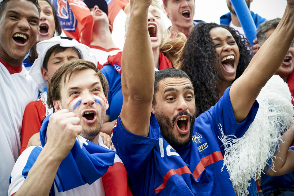 Mingle like a local by catching a game while you're in town. (Photo: PhotoAlto/Frederic Cirou via Getty Images)