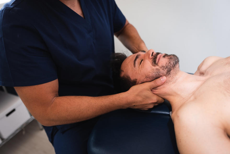 A chiropractor working on a patient