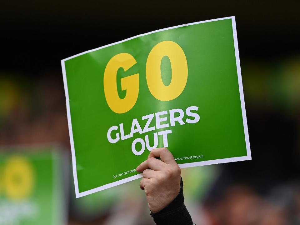 A Manchester United fan holds up a "GO Glazers Out" sign prior to the Premier League match between Manchester United and Fulham at Old Trafford on May 18, 2021 in Manchester, England. A limited number of fans will be allowed into Premier League stadiums as Coronavirus restrictions begin to ease in the UK following the COVID-19 pandemic.