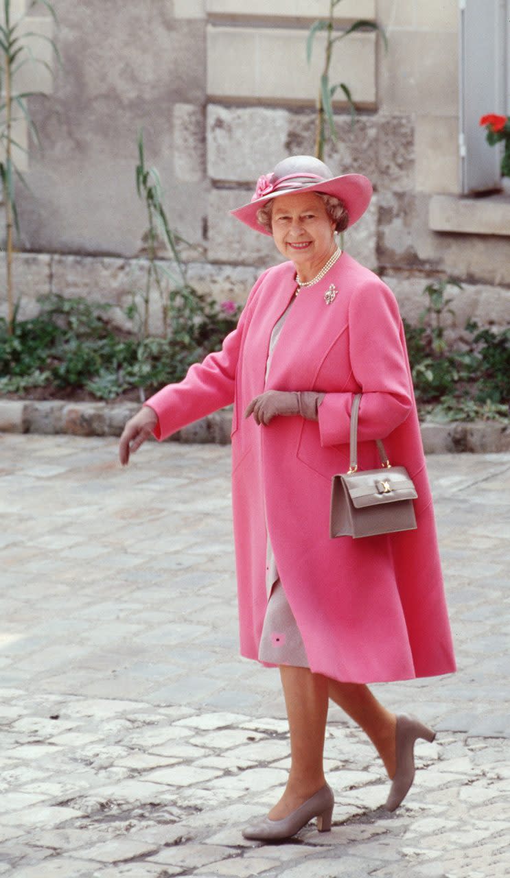 BLOIS, FRANCE - JUNE 11: The Queen On A Visit To Blois In France Wearing A Pink And Taupe Outfit Designed By Fashion Designer Ian Thomas With Colour Co-ordinated Taupe Shoes And Accessories (Photo by Tim Graham Photo Library via Getty Images)