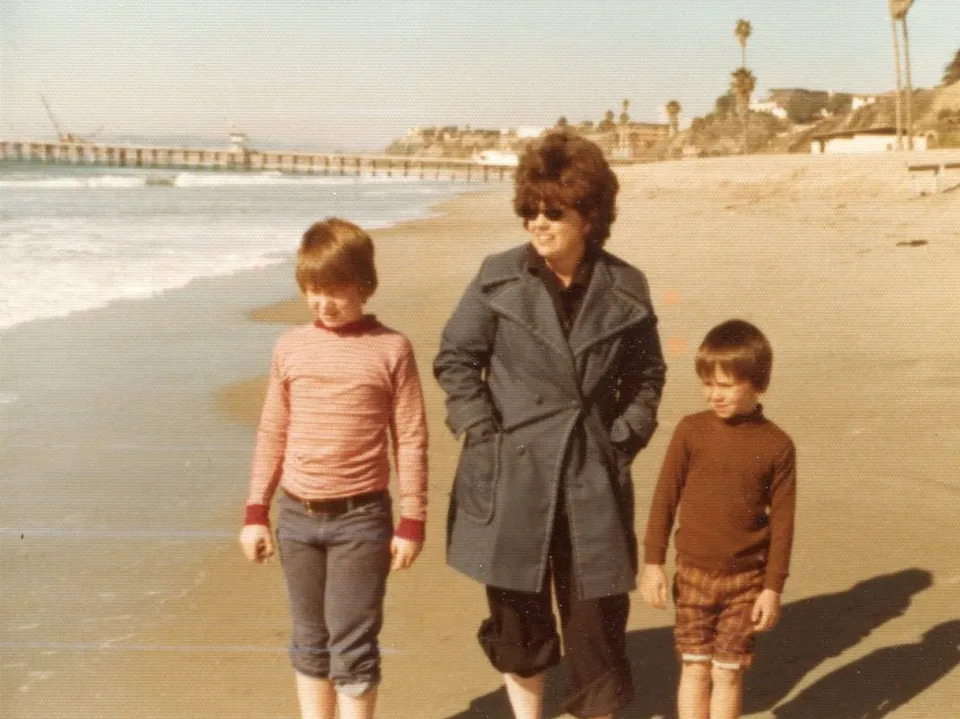Me on the left, walking with my mother and brother on the beach.