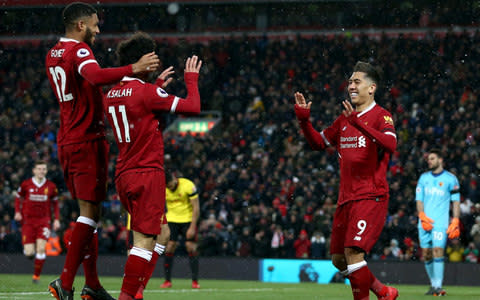 Joe Gomez celebrates with Mo Salah and Roberto Firmino - Credit: Getty images