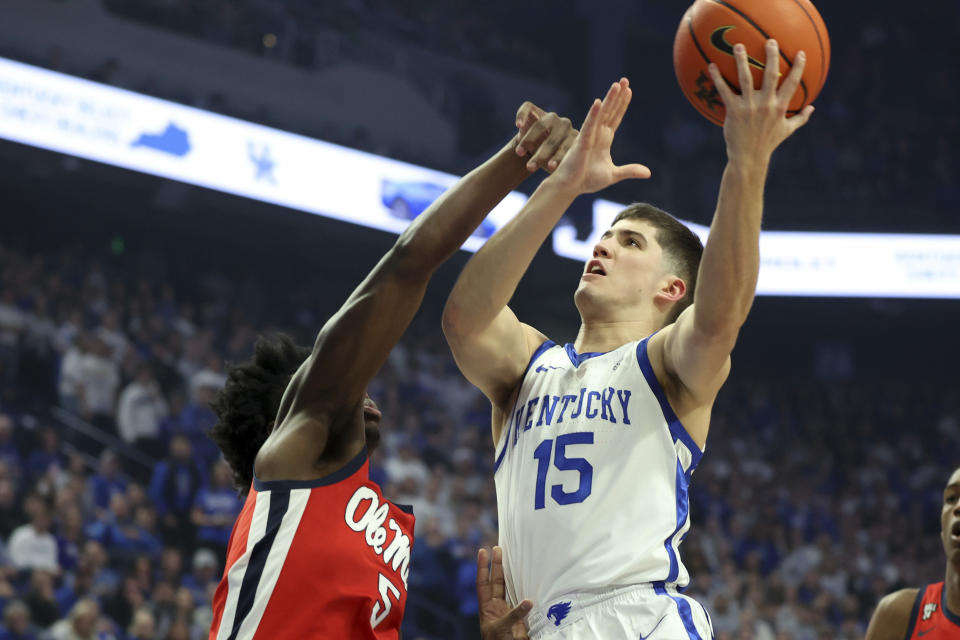 Kentucky's Reed Sheppard (15) shoots while defended by Mississippi's Jaylen Murray (5) during the first half of an NCAA college basketball game Tuesday, Feb. 13, 2024, in Lexington, Ky. (AP Photo/James Crisp)
