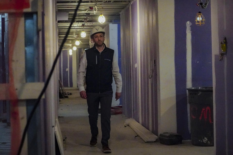 Joey Chilelli, managing director of real estate firm Vanbarton Group, heads for an interview inside his company's high rise in Manhattan's financial district, undergoing conversion from commercial to residential apartments, Tuesday, April 11, 2023, in New York. (AP Photo/Bebeto Matthews)