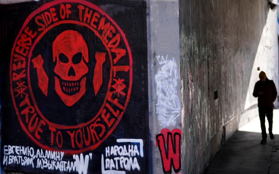 A man walks by a drawn again mural depicting the logo of Russia's Wagner Group on a wall in Belgrade, Serbia, Thursday, Jan. 19, 2023. A friendly, fellow-Slavic nation, Serbia has welcomed the fleeing Russians who need visas to travel to much richer Western European states. But in Serbia, they have not escaped the long reach of Putin's hardline regime influence.Â (AP Photo/Darko Vojinovic) - AP Photo/Darko Vojinovic