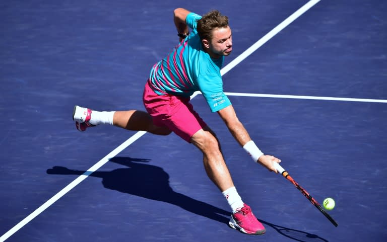 Stan Wawrinka of Switzerland reaches for a forehand return at the net against compatriot Roger Federer during the ATP Indian Wells Masters final match, in California, on March 19, 2017