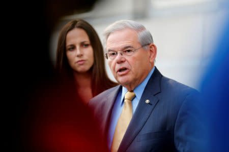 FILE PHOTO: Senator Bob Menendez speaks to journalists after arriving to face trial for federal corruption charges as his daughter Alicia Menendez (L) looks on outside United States District Court for the District of New Jersey in Newark, New Jersey, U.S., September 6, 2017. REUTERS/Joe Penney / File Photo