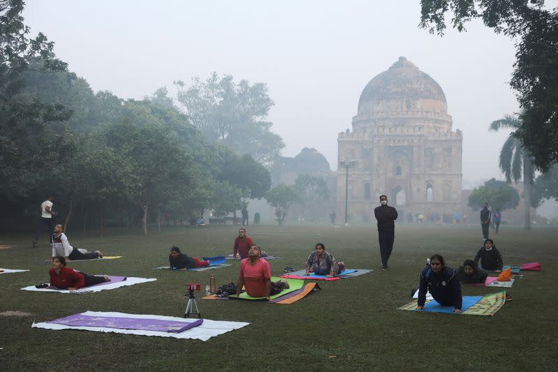 People exercise on a smoggy morning at Lodhi Garden in New Delhi