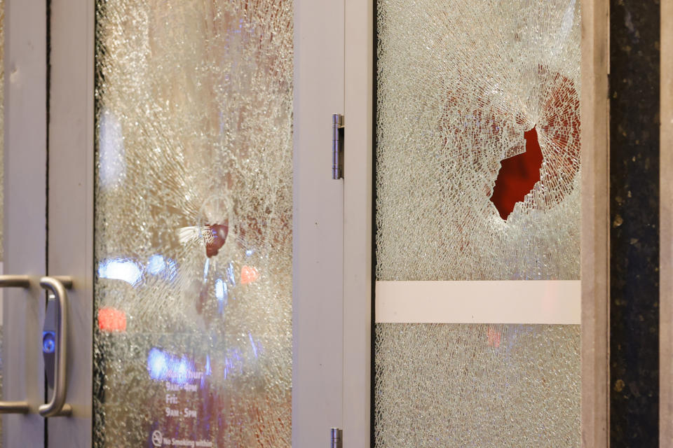 Broken windows at a Wells Fargo branch are seen following a protest, Saturday, Jan. 21, 2023, in Atlanta, in the wake of the death of an environmental activist killed after authorities said the 26-year-old shot a state trooper. (AP Photo/Alex Slitz)