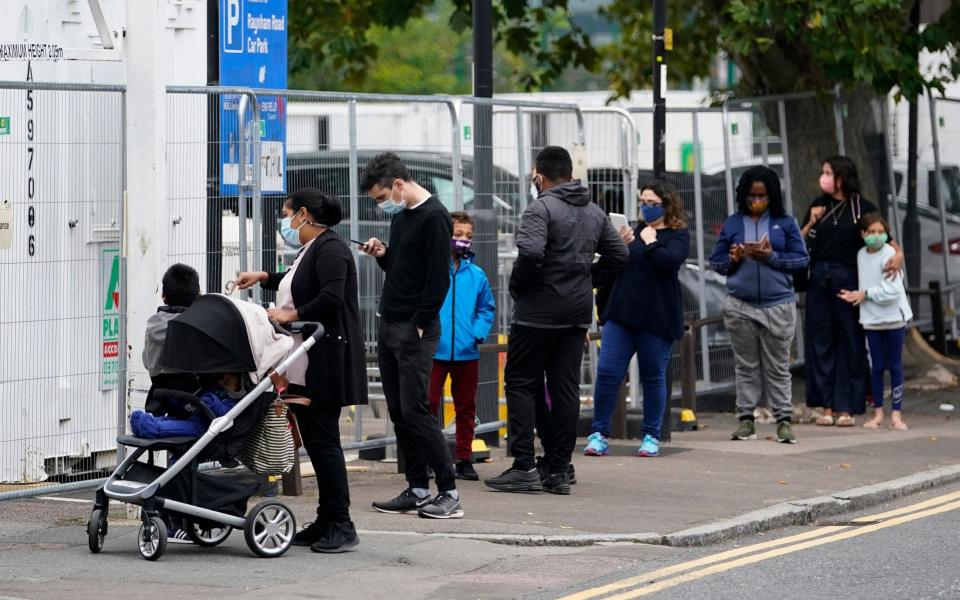 The queue for a testing centre in Edmonton, north London, on Monday - EPA