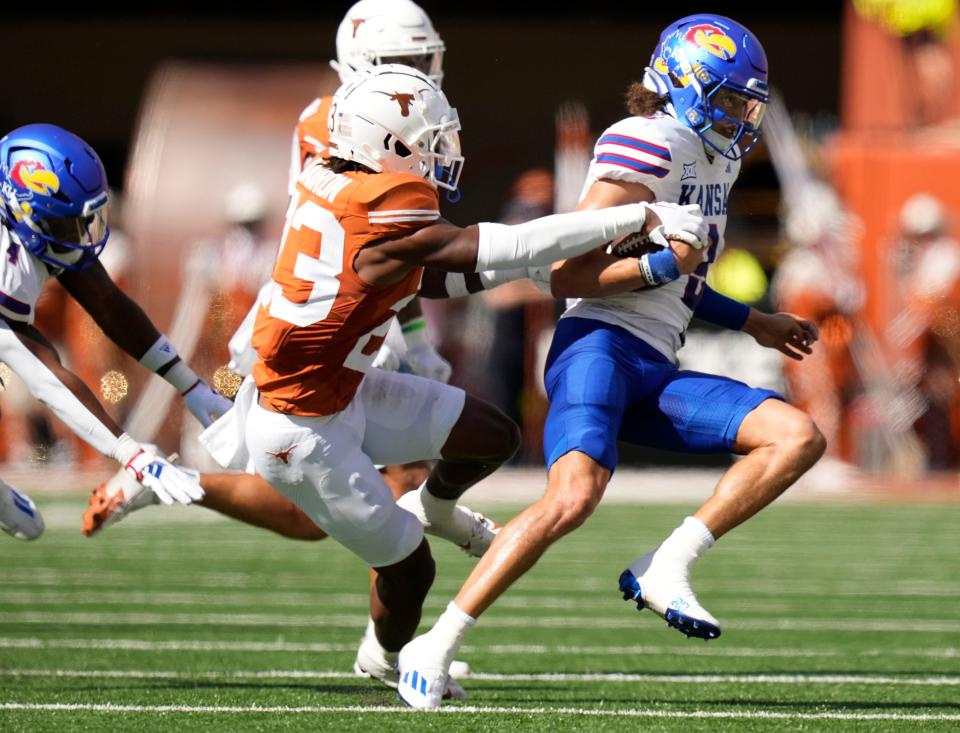 Jahdae Barron, bringing down Kansas quarterback Jason Bean, leads all defensive backs in tackles for Texas.