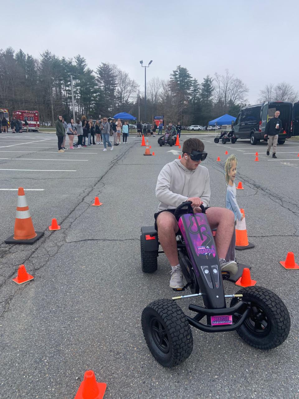 Sean Kelly, a junior at Narragansett Regional High School, attempts to navigate a go-cart while wearing vision-impairment goggles at the school's annual "Gansett Arrives Alive Program" on Thursday, May 2.