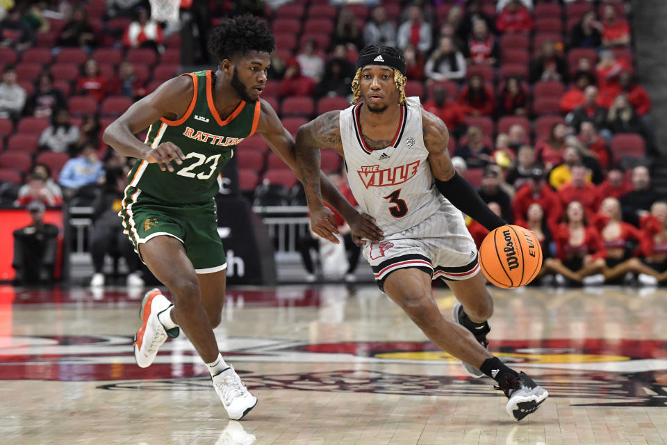 Louisville guard El Ellis (3) drives past Florida A&M guard Jordan Tillmon (23) during the second half of an NCAA college basketball game in Louisville, Ky., Saturday, Dec. 17, 2022. Louisville won 61-55. (AP Photo/Timothy D. Easley)