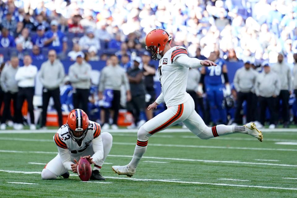 Cleveland Browns place-kicker Dustin Hopkins, right, kicks a 44-yard field goal during the first half of an NFL football game against the Indianapolis Colts, Sunday, Oct. 22, 2023, in Indianapolis. (AP Photo/Michael Conroy)