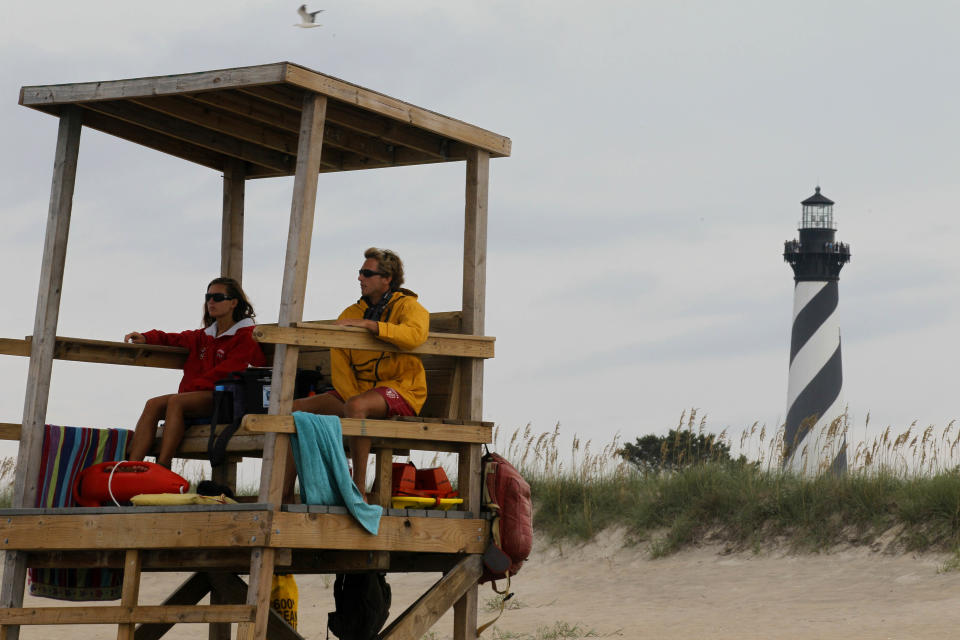 FILE - In this Aug. 24, 2011 file photo, lifeguards keep watch over the beach along the Cape Hatteras National Seashore in Buxton, N.C. Cape Hatteras is number ten on the 2012 list of Top 10 Beaches produced annually by coastal expert Stephen P. Leatherman, also known as "Dr. Beach," director of Florida International University's Laboratory for Coastal Research. (AP Photo/Gerry Broome, file)