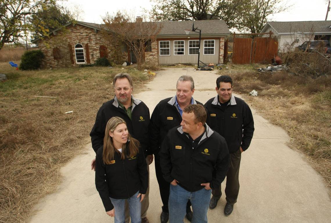 The build team from Wall Homes (front row) Erin Kolp, Kelly Pollard (back row) Jerry Bonesteel, Steve Wall and Jim White stand outside the Augustin family home in unincorporated Tarrant County in 2008. ABC’s Extreme Makeover: Home Edition, with the help of Wall Homes, built the family a new home.