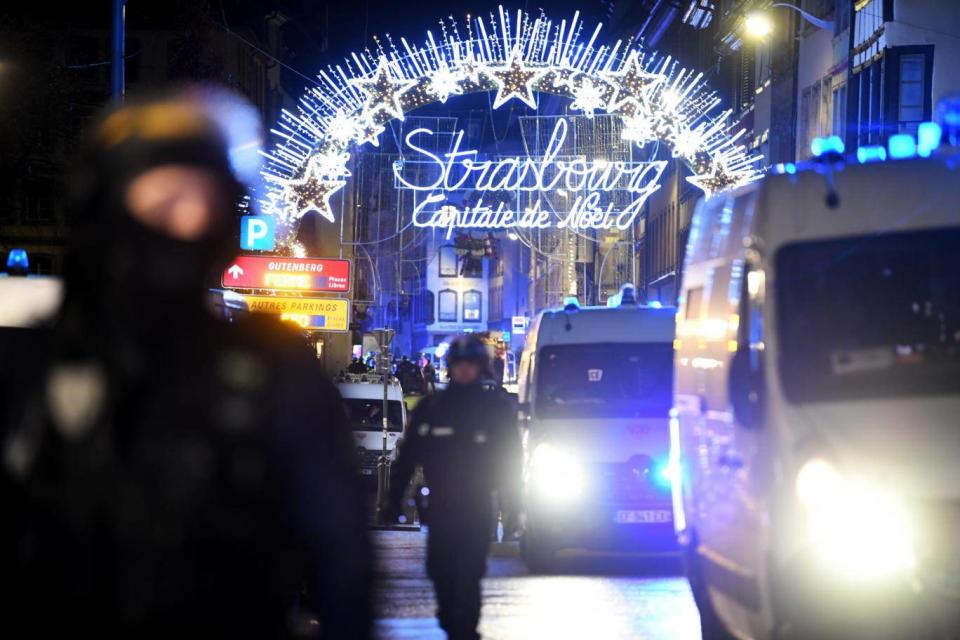 Police officers stand guard near the Christmas market (EPA)