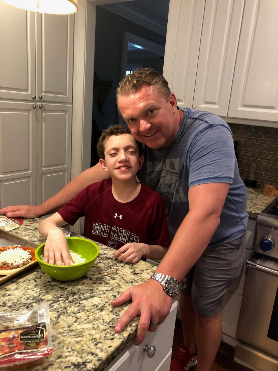 Stone Wolford in the kitchen with his dad, Eric Wolford, Alabama football's new offensive line coach.